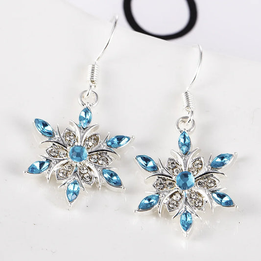 Silberne Ohrringe mit blauen Kristallen, Schneeflocken-Design, eleganter Schmuck, Damenaccessoire.