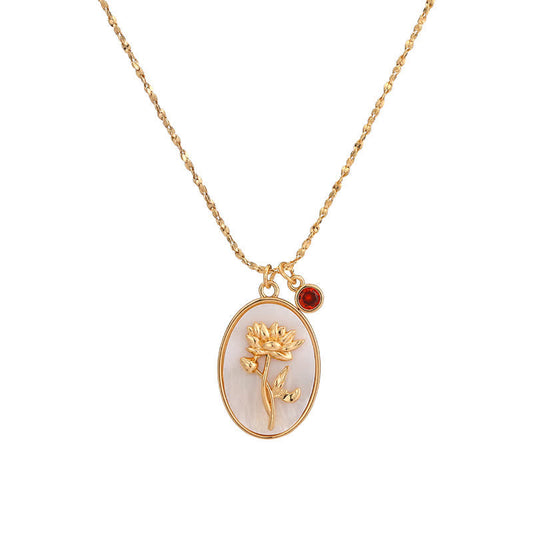 Goldene Halskette mit ovalem Anhänger, Blumenmotiv, roter Edelstein, eleganter Schmuck.
