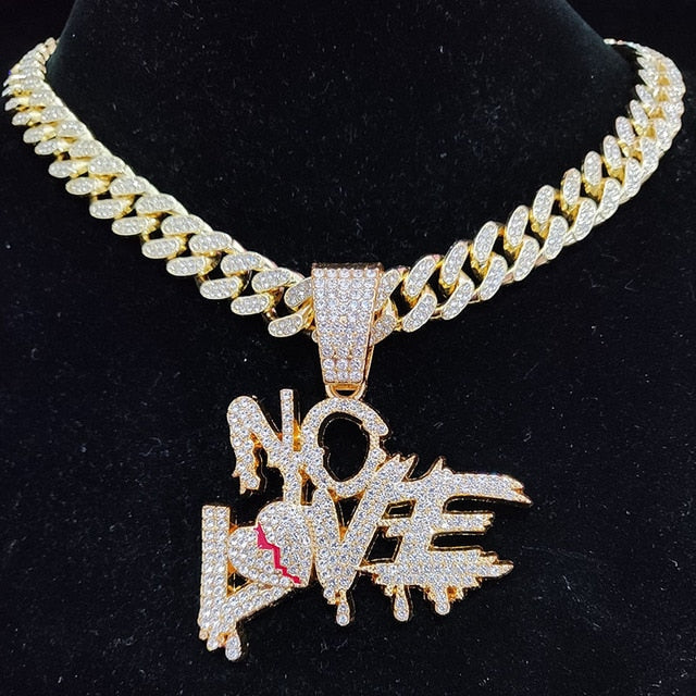 Goldene Halskette mit "No Love"-Anhänger, besetzt mit funkelnden Diamanten.