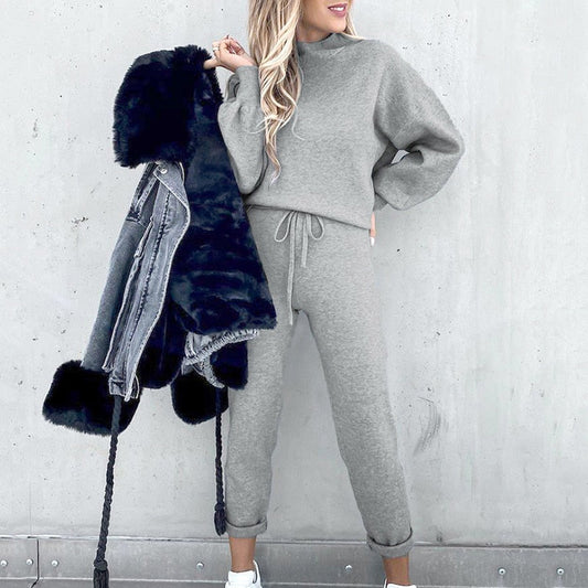 Frau in grauem Jogginganzug mit schwarzer Felljacke, lässige Mode, Winteroutfit.