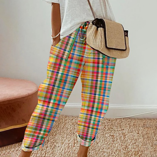 Bunte karierte Damenhose, lässig, Baumwolle, Sommermode, mit weißem T-Shirt und Strohtasche.