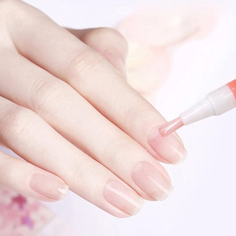 Nahaufnahme einer Hand, bei der ein Stift mit rosa Öl am Nagelbett aufgetragen wird 11