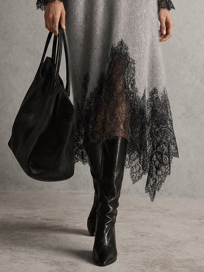 Detailaufnahme des asymmetrischen schwarzen Spitzensaums am grauen Strickkleid, getragen mit Lederstiefeln und Tasche 7
