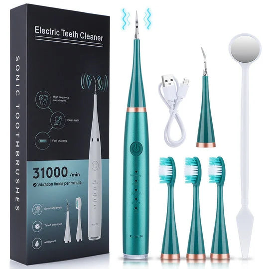Set in Grün mit kupferfarbenen Ringen: Gerät, Box, Ladekabel, Scaler-Aufsatz, drei Bürstenköpfe und Mundspiegel. 5