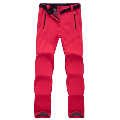Rote Outdoor-Hose, wasserdicht, mit Reißverschlusstaschen, ideal für Wandern und Trekking.