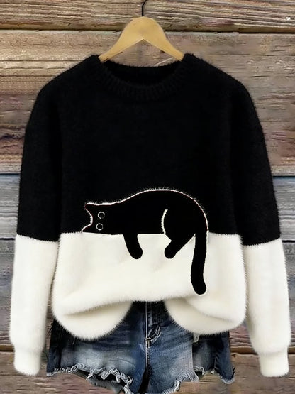 Flauschiger Pullover in Schwarz und Weiß mit schwarzer Katze, am Holzbügel vor Jeansshorts 5