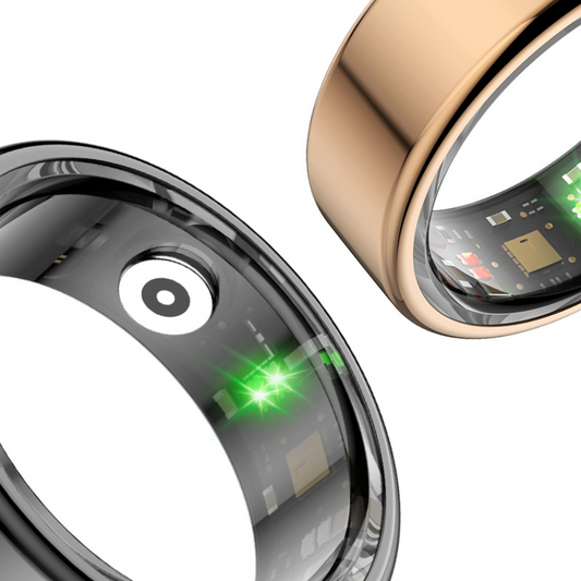 Zwei Smart-Ringe, schwarz und gold, mit Sensoren und Elektronik, Nahaufnahme.