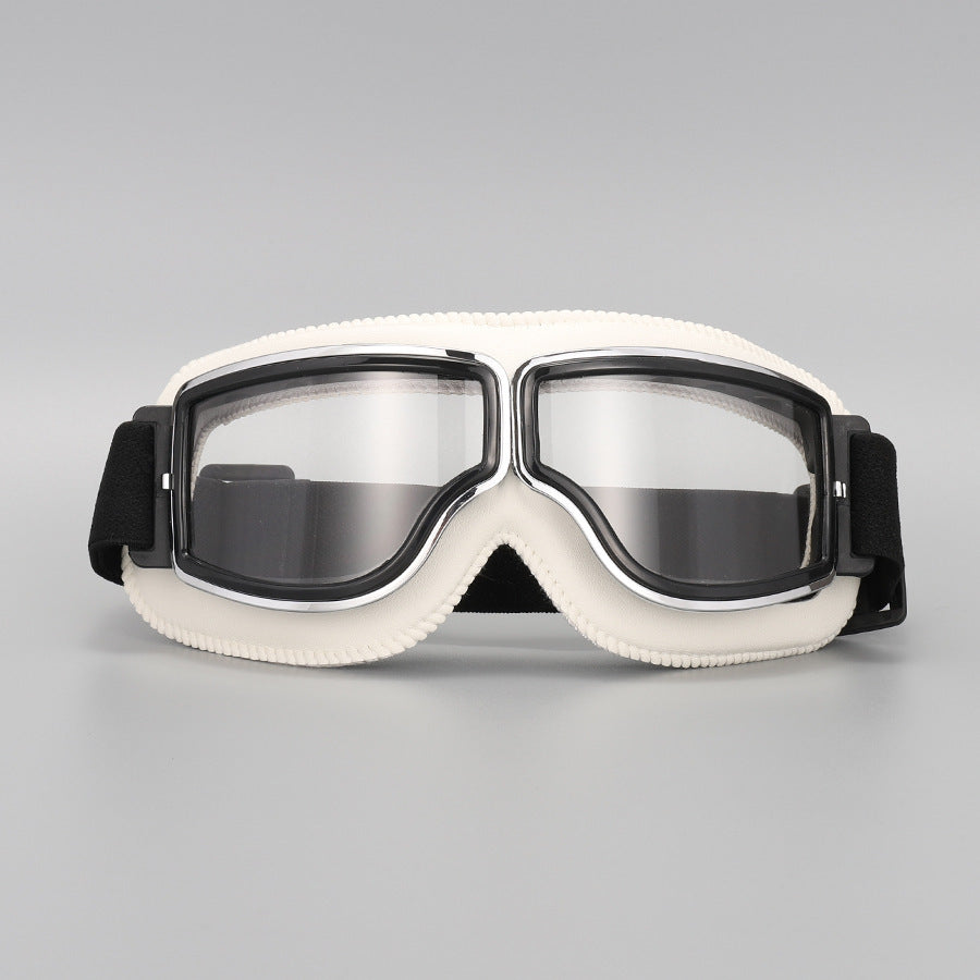 Fliegerbrille mit cremeweißer Polsterung, Chromrahmen und klaren Gläsern, Vorderansicht mit schwarzem Band. 13