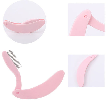 Rosa, klappbarer Wimpernkamm aus Kunststoff für präzises Trennen und Stylen der Wimpern.