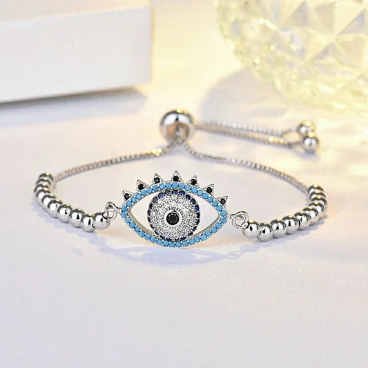 Silberarmband mit blauem Auge-Anhänger, Kristallsteine, verstellbar, modisches Schmuckstück.