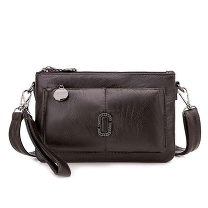 Schwarze Lederhandtasche mit Reißverschluss und abnehmbarem Schulterriemen, elegant und modisch.