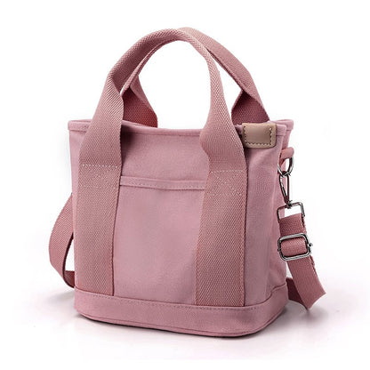 Rosa Canvas-Handtasche mit verstellbarem Schultergurt, modisch und praktisch für Damen.