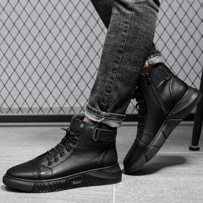 Schwarze Herren-Sneaker aus Leder, hohe Knöchel, modern, lässig, vor Gitterhintergrund.