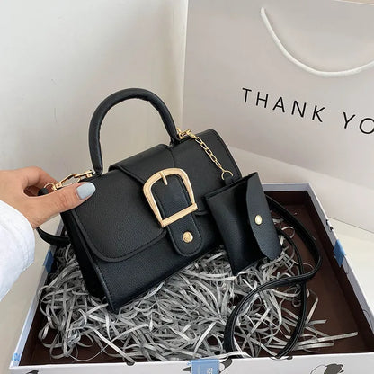 Schwarze Lederhandtasche mit goldener Schnalle, elegantes Design, Damenmode Accessoire.
