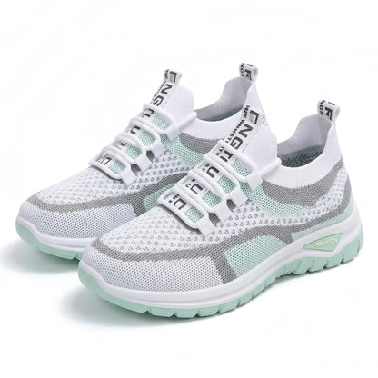 Paar weißer Mesh-Sneaker mit mintgrünen Details und Gummischlaufen statt klassischer Schnürung in schräger Ansicht 16
