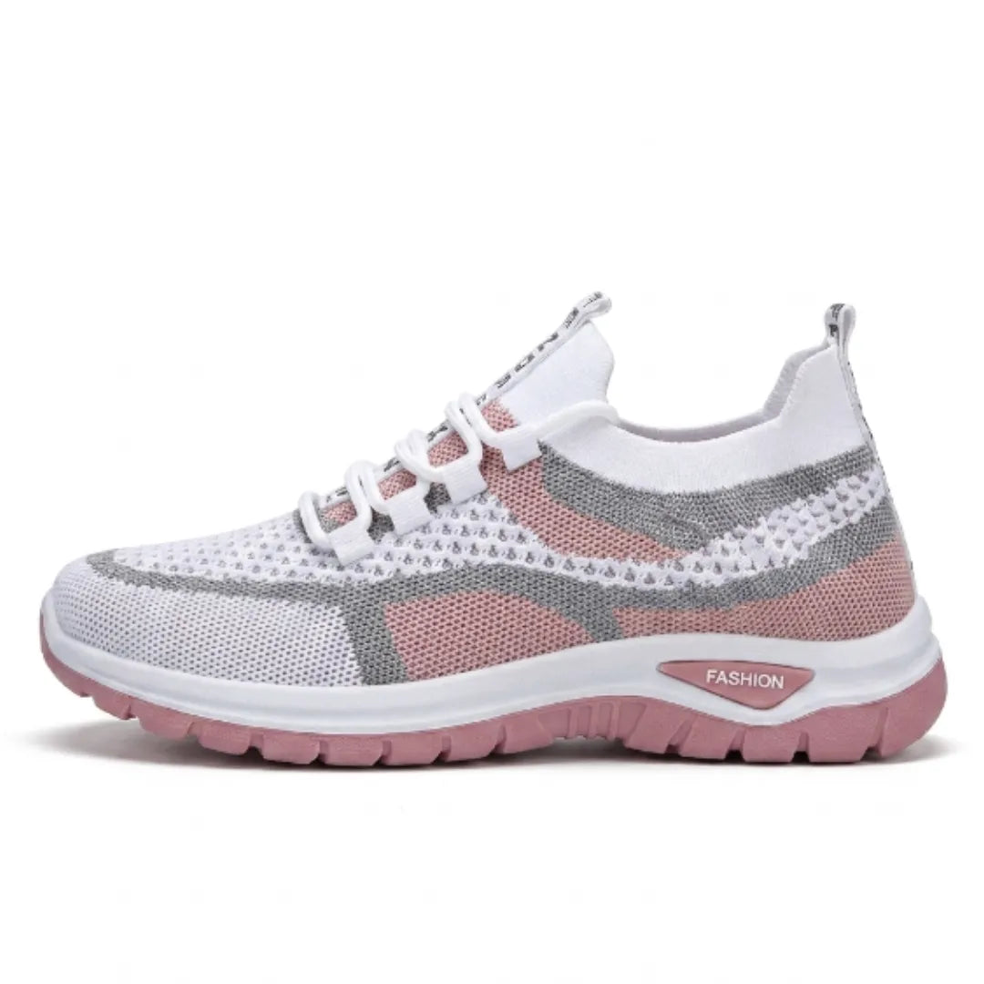 Seitenansicht des Mesh-Sneakers in Weiß mit rosa Akzenten, grauen Linien und rosa Sohle 19