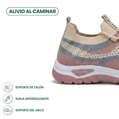Detailansicht der Ferse des beigen Mesh-Sneakers mit rosa Akzenten, rutschfester Sohle und Infosymbolen zu Fersen- und Gewölbeunterstützung. 31