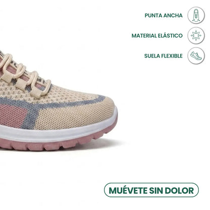 Nahaufnahme der breiten Schuhspitze des beigen Mesh-Sneakers mit rosa Akzenten und Symbolen für weite Zehenbox, elastisches Material und flexible Sohle. 32
