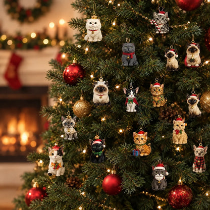 Verschiedene kleine Katzenfiguren mit Weihnachtsmützen hängen als Schmuck an einem beleuchteten Tannenbaum, im Hintergrund brennt ein Kamin. 1