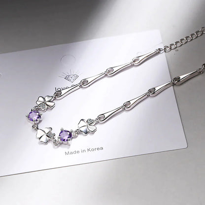 Silberne Halskette mit Schmetterlingsanhängern und lila Kristallen, Made in Korea.