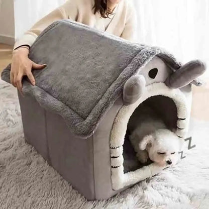 Graue Indoor-Hundehütte aus weichem Material mit abnehmbarem Kissen, geeignet für kleine Hunde.