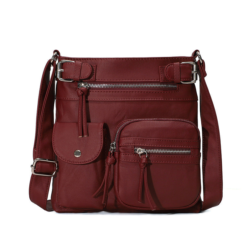 Rote multifunktionale Anti-Diebstahl-Tasche aus Leder mit mehreren Reißverschlusstaschen.