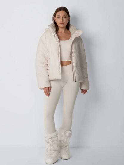 Ganzkörper-Frontansicht in Creme: offene Jacke über Crop-Top, Leggings und fellbesetzten Winterstiefeln 5