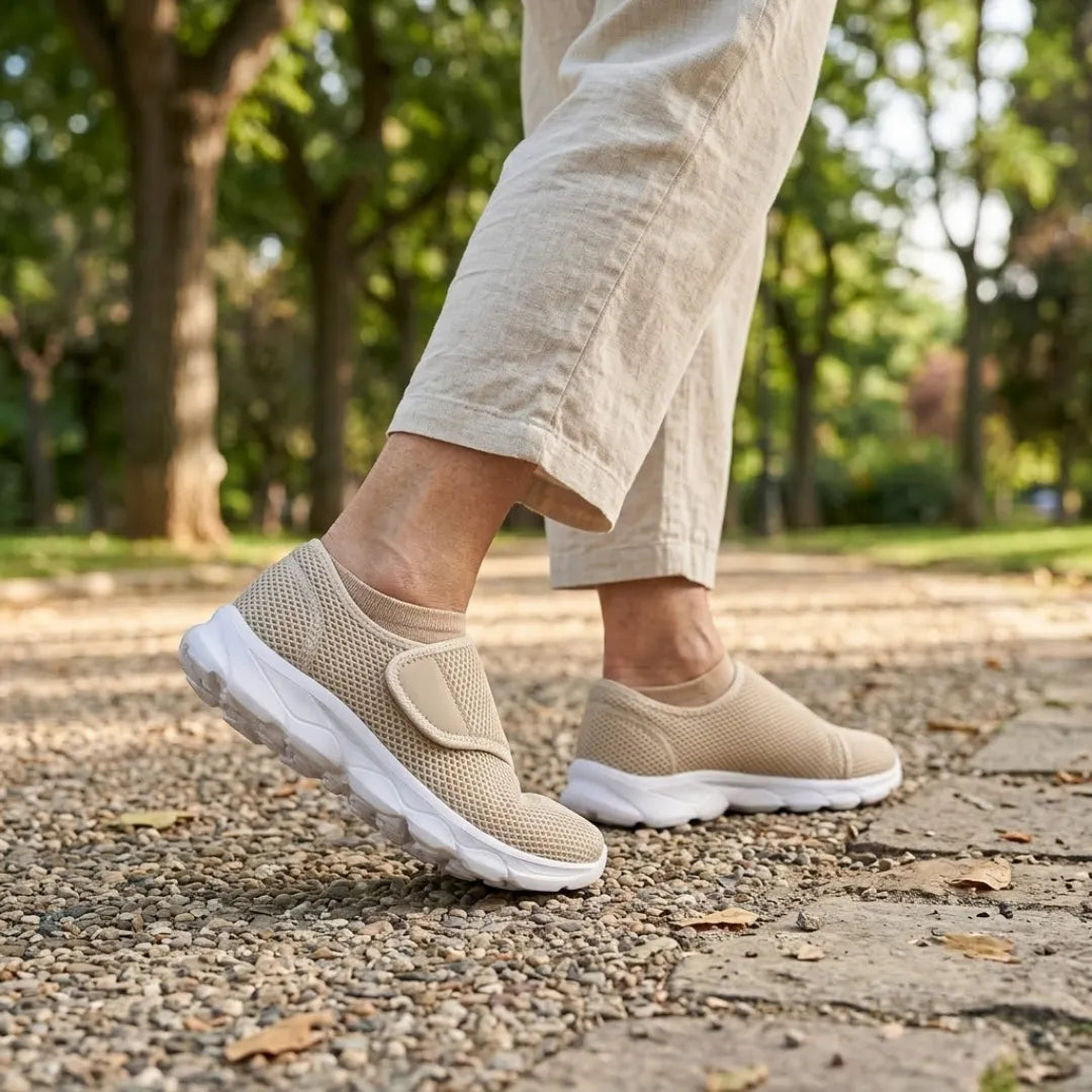 Person in hellen Leinenhosen geht auf einem Parkweg mit Kies in beigen Netzschuhen mit Klettverschluss und weißer Sohle. 29