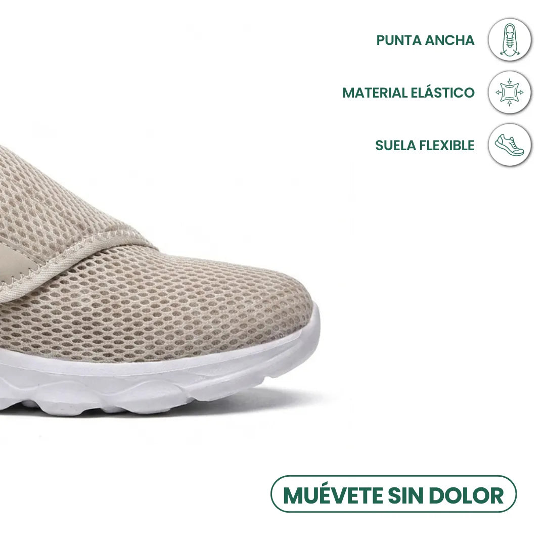 Nahaufnahme der Schuhspitze des beigen Netzschuhs mit breiter Zehenbox, elastischem Material und flexibler weißer Sohle, Merkmale mit Symbolen markiert. 32