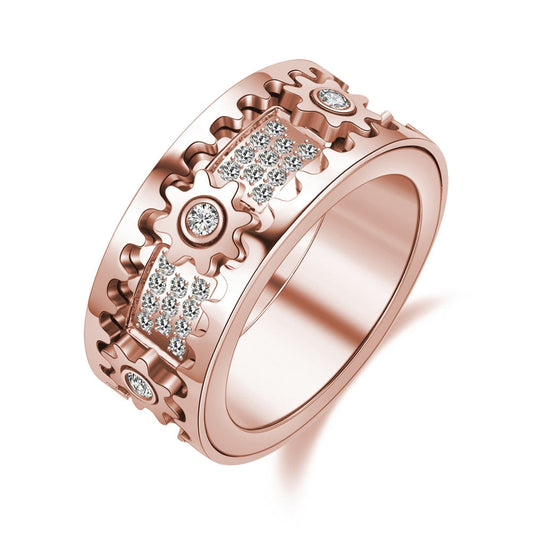 Roségoldener Ring mit Zahnraddesign und funkelnden Kristallen, modischer Schmuck für Damen.