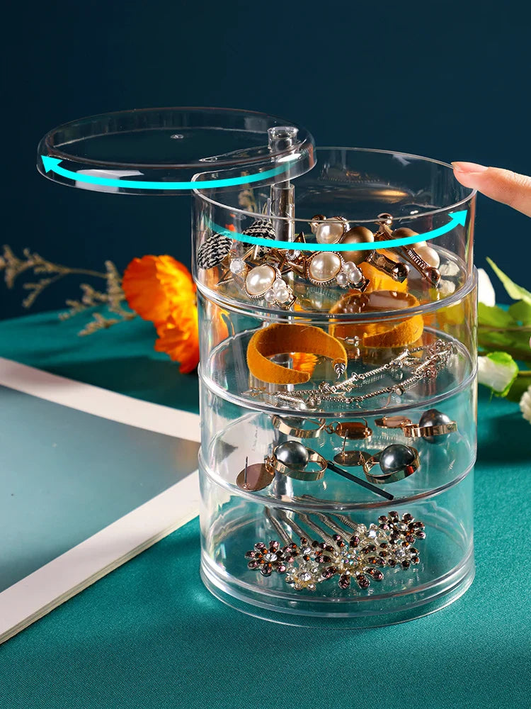 Transparente Schmuckbox aus Acryl mit drehbaren Fächern, ideal zur Schmuckaufbewahrung.