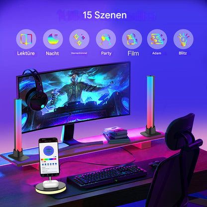 Gaming-Setup mit LED-Lichtleisten, RGB-Beleuchtung, Monitor, Tastatur, Kopfhörer, Smartphone.