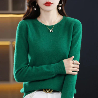 Smaragdgrüner Rundhalspullover mit gerippten Bündchen, getragen zu weißer Hose und schwarzem Gürtel 6