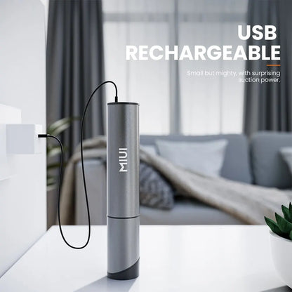 Grauer USB-aufladbarer Handstaubsauger, kompakt, leistungsstark, modernes Design, Wohnzimmer.