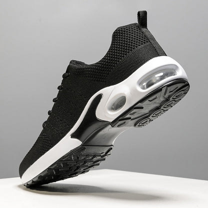 Schwarzer Sportschuh mit weißer Sohle, atmungsaktives Mesh, Herren Sneaker, seitliche Ansicht.