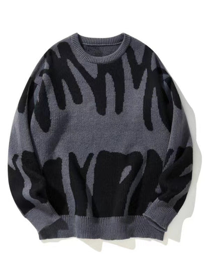 Strickpullover mit abstraktem Muster in Schwarz auf grauem Grund, flach von vorn fotografiert 1