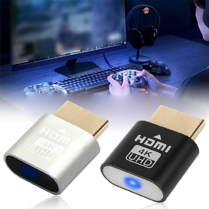 Silberne und schwarze Ausführung des Steckers nebeneinander, im Hintergrund eine Person mit Gamecontroller an einem Schreibtisch mit Monitor, Tastatur und Kopfh 10