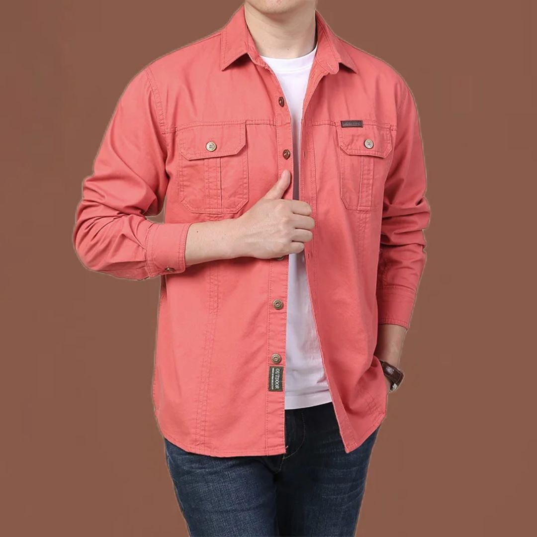 Mann in korallrotem Hemd aus Baumwolle, lässiger Stil, Jeans, brauner Hintergrund.