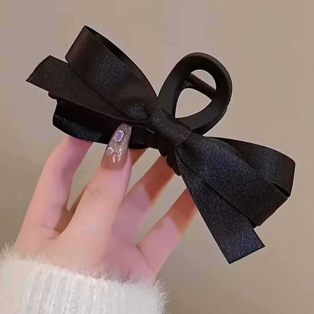 Schwarze Haarklammer mit Schleife, elegantes Design, Haaraccessoire für Damen.