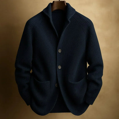 Dunkelblaue Strickjacke mit Schalkragen, drei Knöpfen und zwei Taschen, auf Bügel vor goldbraunem Hintergrund 3