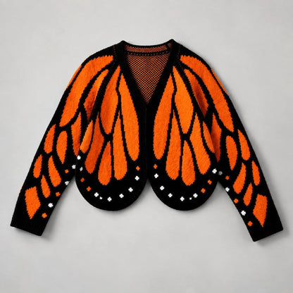 Flach ausgelegte Strickjacke mit orangefarbenem Flügelmuster auf schwarzem Grund, runder Saum und weiße Punkte 2