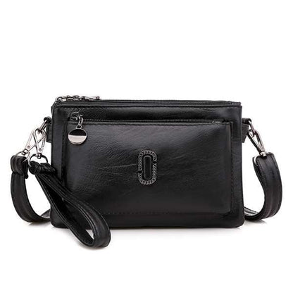 Schwarze Lederhandtasche mit Reißverschluss, abnehmbarer Schulterriemen, elegantes Design.