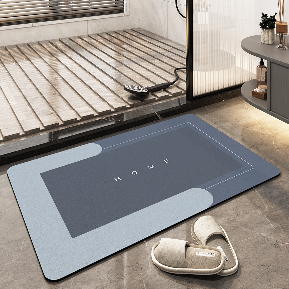 Graue Badematte mit "HOME"-Aufschrift, rutschfest, saugfähig, Badezimmer, modern, rechteckig.