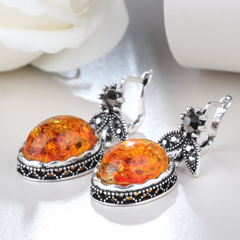 Silberne Ohrringe mit Bernstein, florales Design, Damen-Schmuck, eleganter Stil.