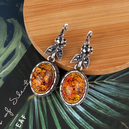 Silberne Ohrringe mit Bernstein, oval, filigranes Design, Schmuck für Damen, elegant.