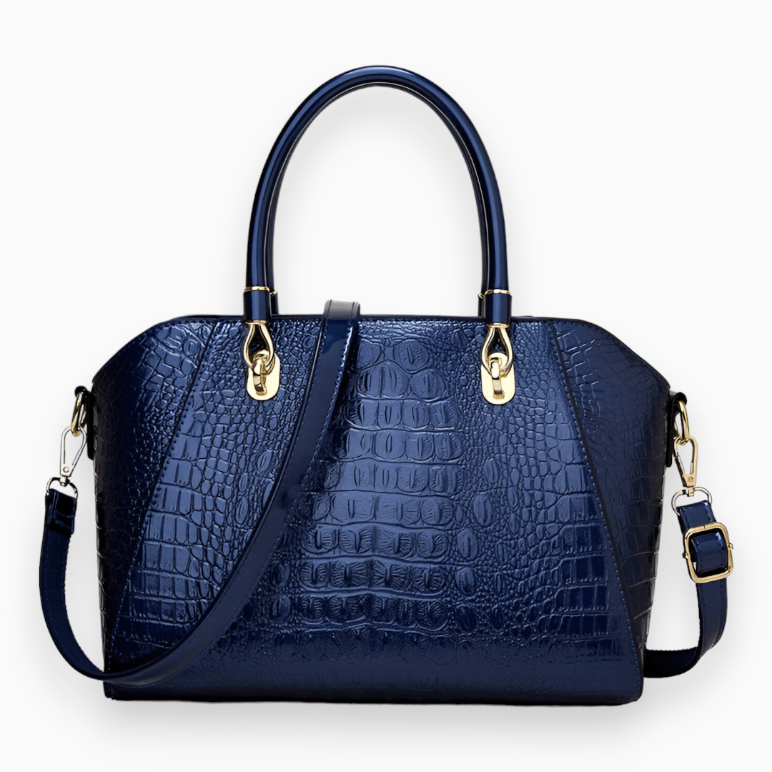 Dunkelblaue Krokodilleder-Handtasche mit goldenen Beschlägen und abnehmbarem Schulterriemen.