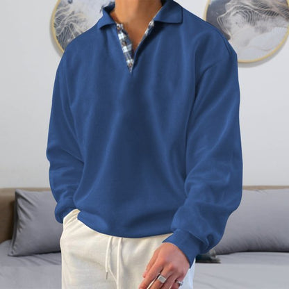 Mann in blauem Polohemd und weißen Hosen im Wohnzimmer, moderne Wanddekoration.
