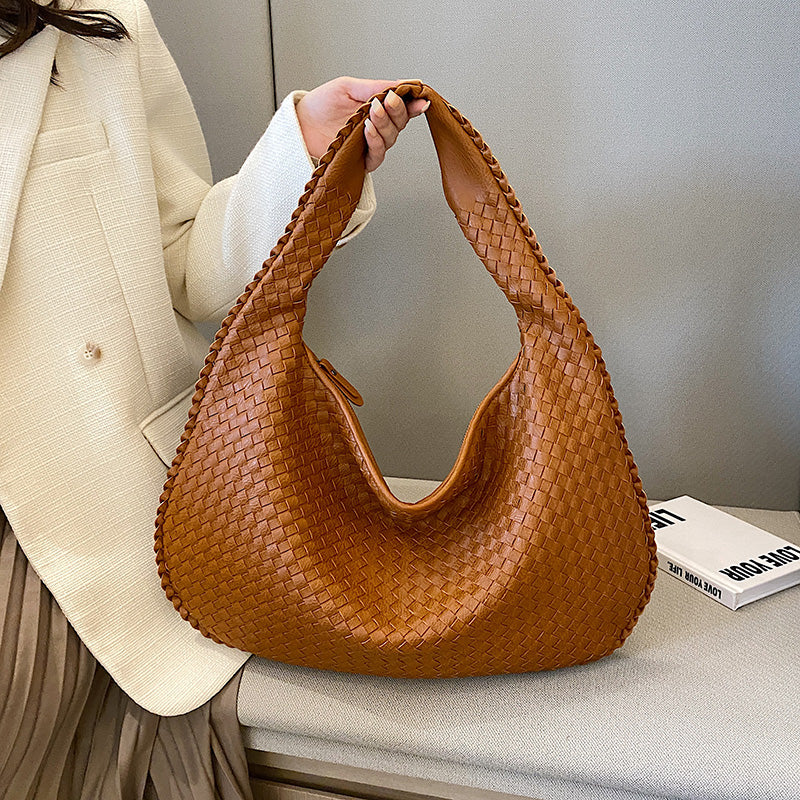 Braune geflochtene Lederhandtasche, modisch, Damenaccessoire, elegantes Design.