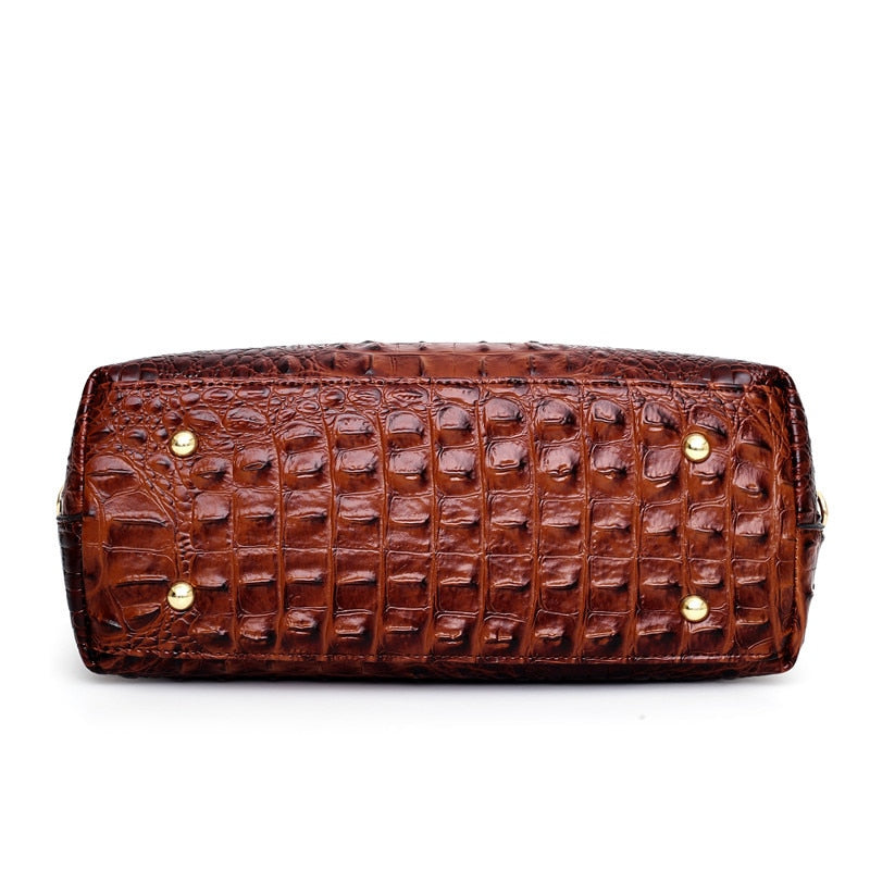 Braune Lederhandtasche mit Krokodilprägung, elegante Damenmode, luxuriöses Accessoire.