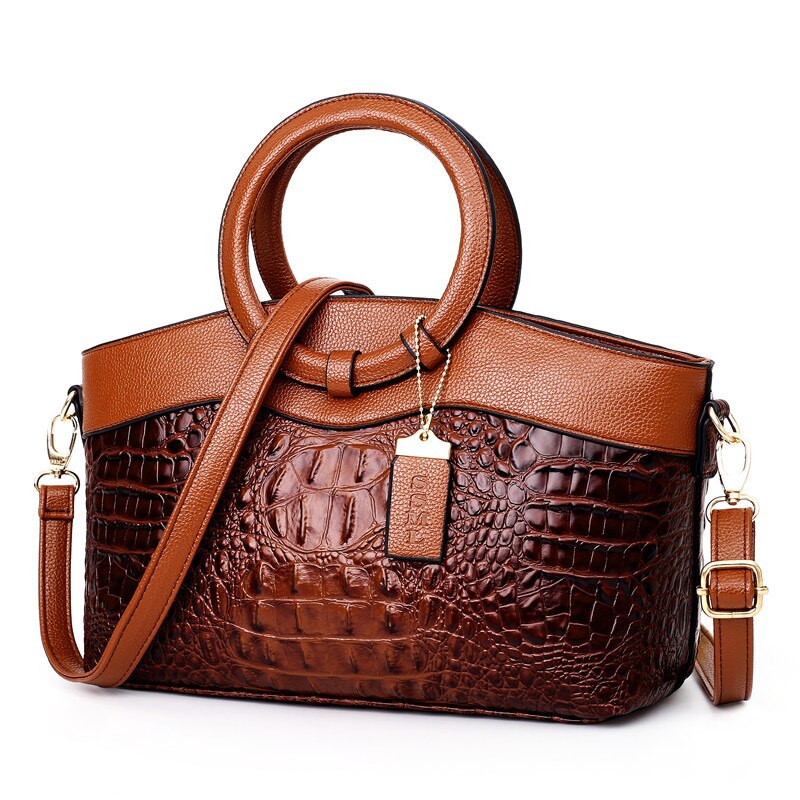 Braune Krokodilleder-Handtasche mit Rundgriffen und Schulterriemen, elegant und modisch.